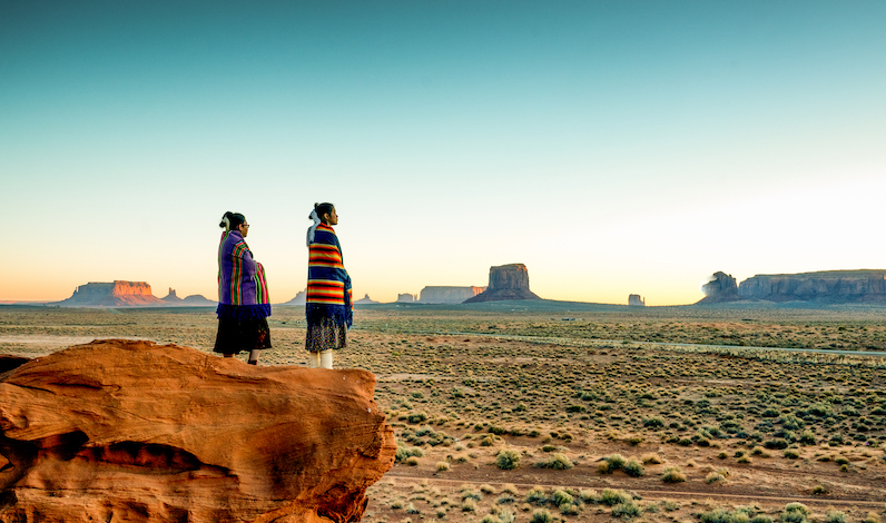 Two indigenous women looking off into the distance.