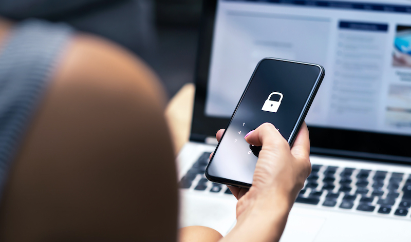 Woman holding iphone with lock symbol on the screen.