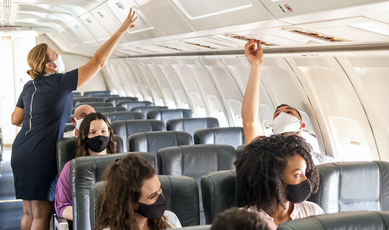 Passengers on airplane wearing masks.